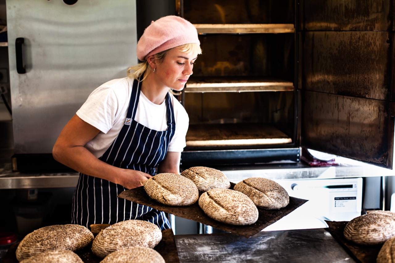 women bake bread in a bakery