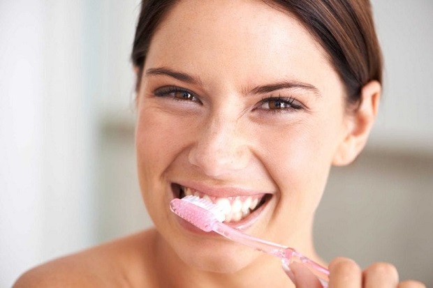 picture of a woman brushing her teeth