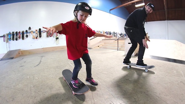 kid skateboarding on a complete skateboard