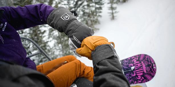 fist bump with snowboard gloves on close up