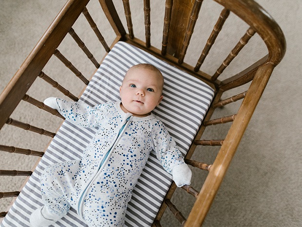 picture of a baby in a bed wearing bodysuit for newborn 