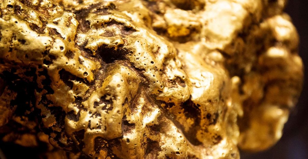 Gold is a mineral that can be found in veins and placer deposits. When lava gets to the surface, it makes a vein, which is also called a gold vein. As the lava cools, it gives off a lot of gases and liquids. Most of these liquids and gases move through cracks in the lava and leave behind minerals as they go. This makes a vein. Some of these veins are miles long! When these veins reach the surface, wind, weather, and water break them up and carry the gold away.