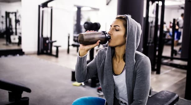 girl drinking from a protein shaker