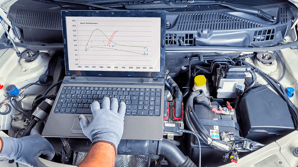Mechanic remapping the car from laptop.