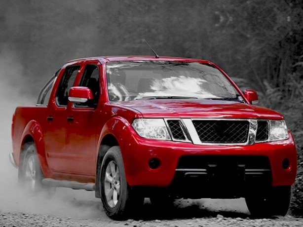Red Nissan Navara D22 driven in nature