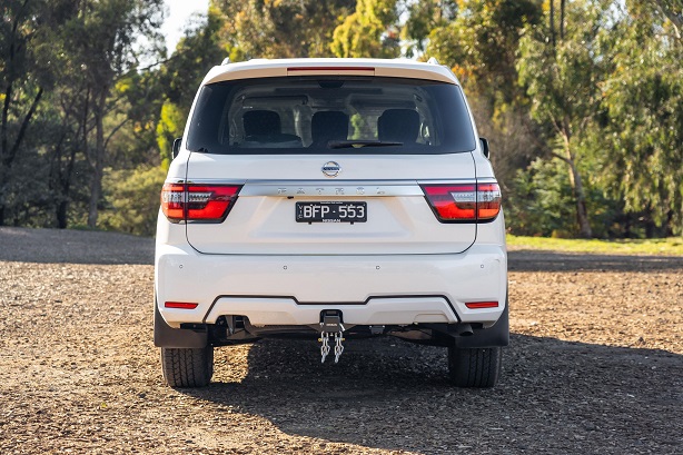 White Nissan Patrol with stock exhaust parked in nature