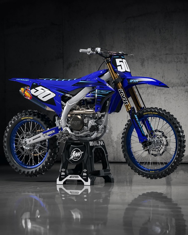 A blue motocross dirt bike with high-quality aftermarket plastics on it